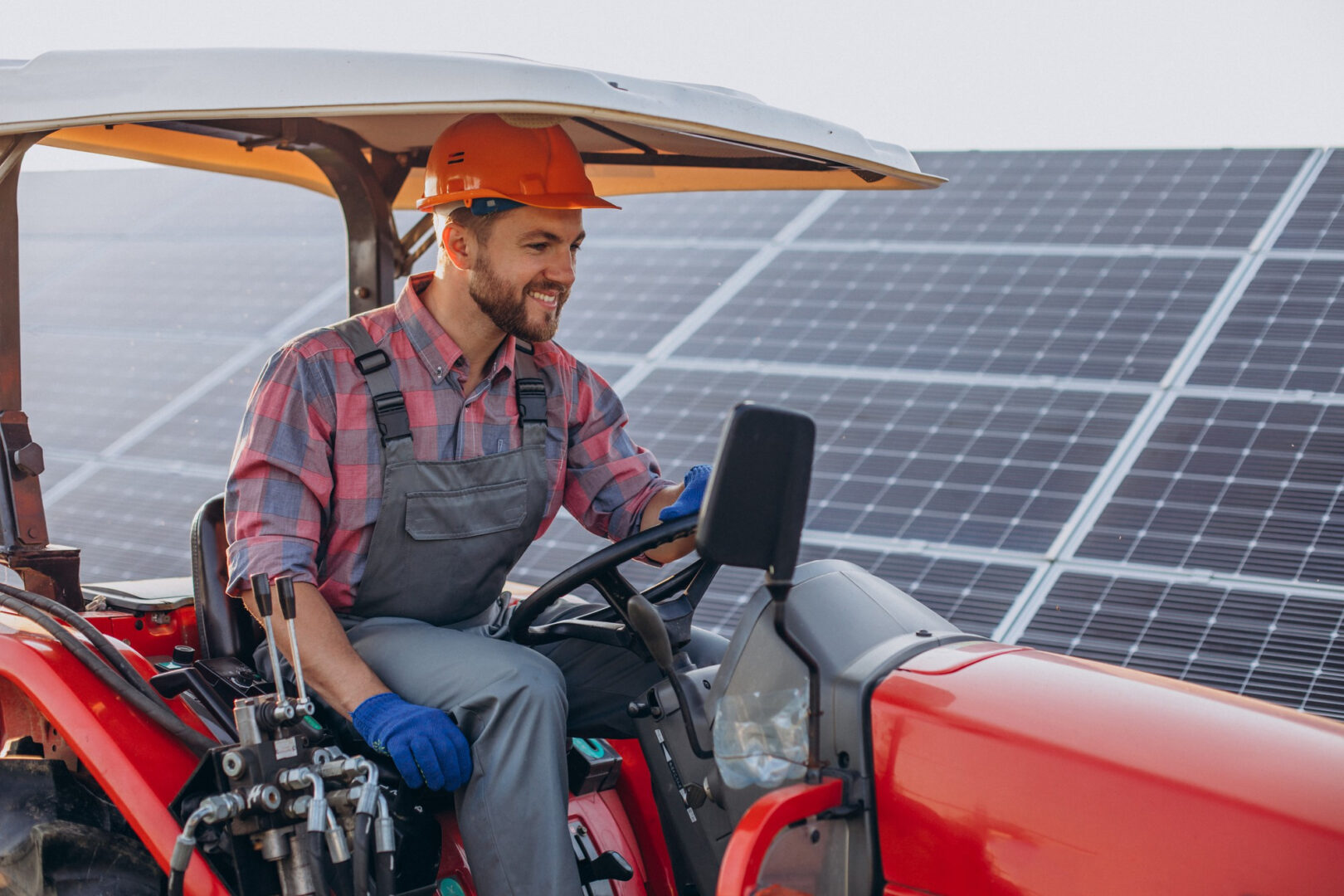 USE CASES OF SOLAR PANEL ENERGY IN AGRICULTURAL FARMS 5 A man driving a truck past solar panels on a farm, solar panels for farms providing renewable energy for agriculture